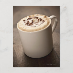 En mugg av Cappuccino-kaffe med smält innehåll Vykort