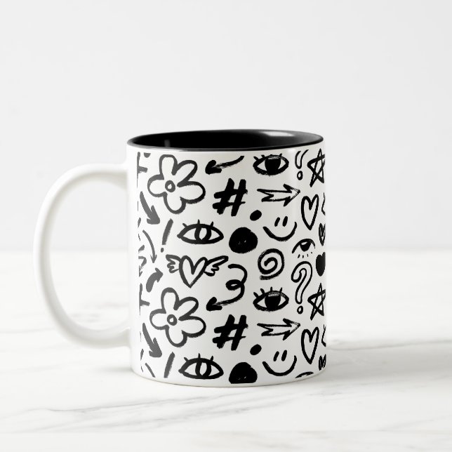 En mugg med en vacker, modern design i svart och v (Vänster)