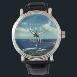 En positiv syn på livet ©Sjölandskap Armbandsur<br><div class="desc">Denna utformning har en bakgrund av ett originalfotografiskt verk som skildrar ett vackert kusten med blå himmel och vita moln, åtföljt av ett inspirerande budskap i mitten: "ALWAYS LOOK ON THE BRIGHT SIDE OF LIFE" i typografisk konst. Denna fras förmedlar en optimistisk inställning till livet - oavsett vilka svårigheter ett...</div>