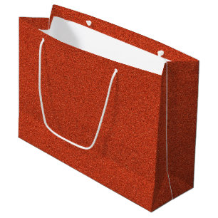 En röd glitterpapper påse