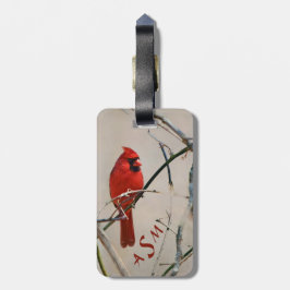 En röd huvudsaklig fågel på en gren i skogen bagagebricka