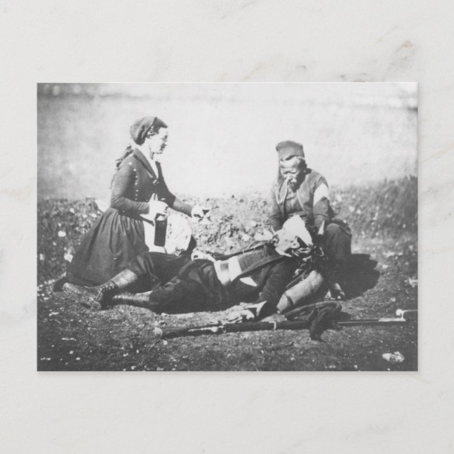 En sjuksköterska som tar emot en sårad man vykort (Framsida)