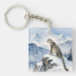 En snöleopard på snötäckt topp
