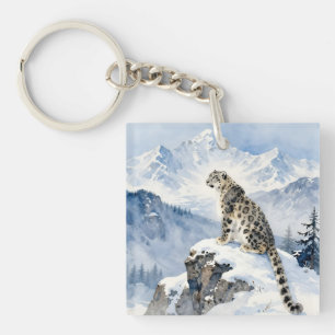 En snöleopard på snötäckt topp
