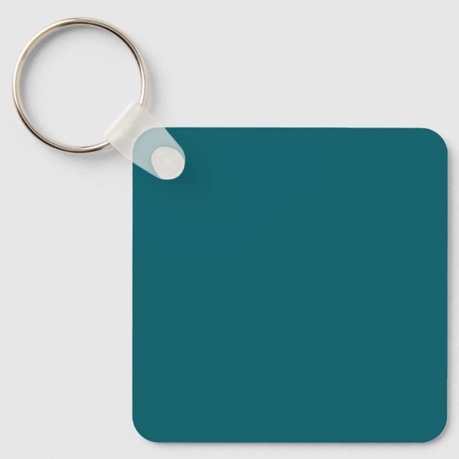 En solid teal bakgrund fyller hela ramen nyckelring (Framsida)