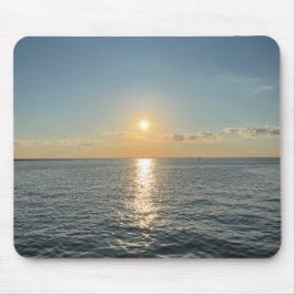 En solnedgång över lugnen vatten musmatta