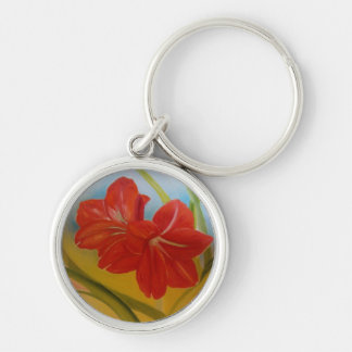En sorts nyckelkedja med en blommigt!!!! rund silverfärgad nyckelring