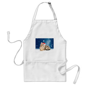 En söt katt som bär röd tomteluva jul snö förkläde