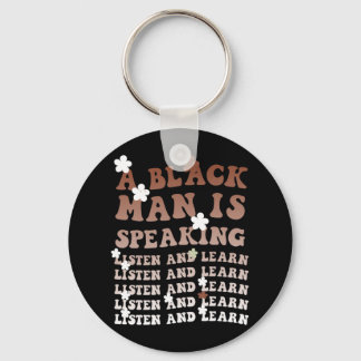 En svart man talar och lär sig svart. nyckelring