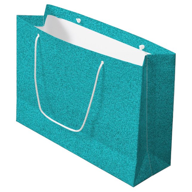 En teal glitterpresentpåse med vita repetiska (Framsidan Vinklad)