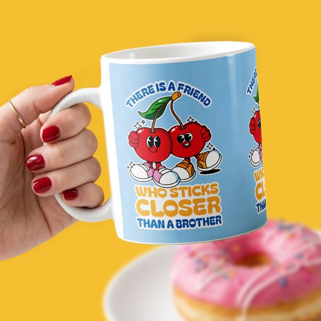 En vän håller fast hårdare än en bror kaffemugg (A cheerful friendship mug inspired by Proverbs 18:24, featuring two playful cherries.)
