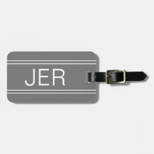 Enkel modern stilfull grå resväska med monogram bagagebricka