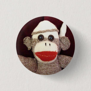 Ernie som sock monkeyansiktet klämmer fast knapp