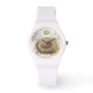 Ett fågelbo med ett grönt ägg armbandsur