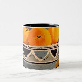 Ett fantastiskt mugg med orangar som målar upp des