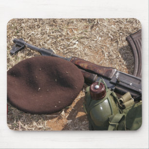 Ett gevär, militär täcker och kantinen musmatta