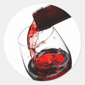 Ett glas rött vin runt klistermärke