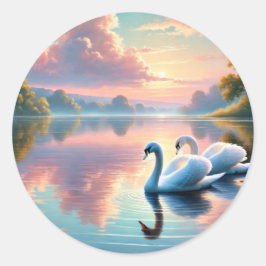 Ett par svanar glider på en serene sjö runt klistermärke