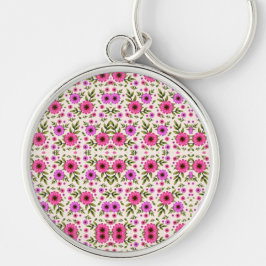 Ett runt nyckelband med en färgrik blomster rund silverfärgad nyckelring
