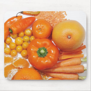 Ett val av orangefrukter & vegetables. musmatta