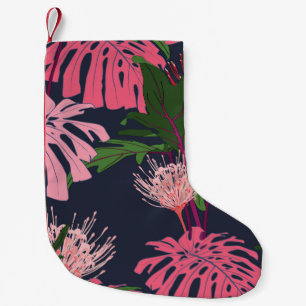 Exotisk grönt och rosa tropiska löv handflatan och liten julstrumpa