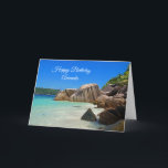 Fågeldagen i Kusten vid Tropiska havet Rocky Kort<br><div class="desc">Ett hälsningskort med ett foto av en turkotisk blå havsstrand med stort sten utspridt längs kusten. Ljus och soligt tropiskt språk.</div>