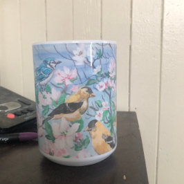Fåglar i gult av blått jay på bakgården kaffemugg
