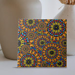 Färg Blommigt Oriental Ethnic Mandalas Mönster Kakelplatta<br><div class="desc">Den här keramiska plattan innehåller utförliga beskrivningar av manalaliknande motiv som ger ett kaleidoskopiskt intryck. Panelen har två stora mönster: ett som liknar ett lysande sol och ett annat som består av komplicerat lagrar av geometriskt figurer som ordnats i cirkelformade konfigurationer. Gult, rött, blått och svart dominerar paletten färg, som...</div>