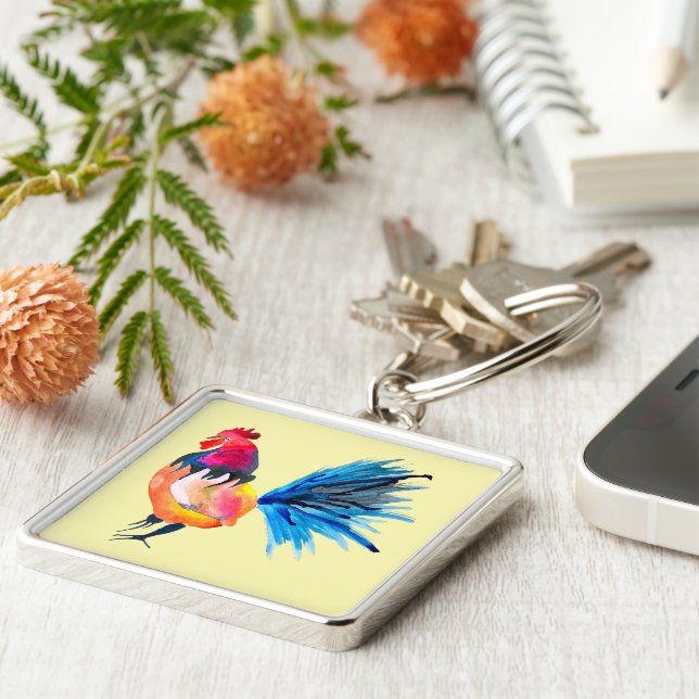 Färgfull vattenfärgsillustration i tupp fyrkantig silverfärgad nyckelring (Sidan)