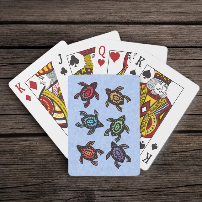 Färgglada abstrakta simmande sköldpaddor spelkort (Group of black abstract turtles colourful shells on blue deck of playing cards.)