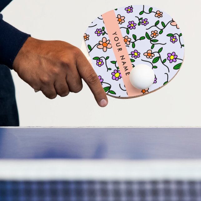 Färgglada blommor, blå bakgrund, orange pingisracket (Insitu)