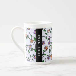 Färgglada blommor, blå bakgrund, svart benporslin mugg