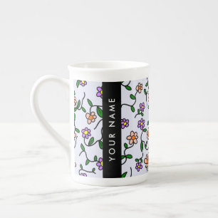 Färgglada blommor, blå bakgrund, svart benporslin mugg