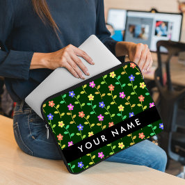 Färgglada blommor, grön bakgrund, svart laptop fodral