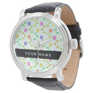Färgglada blommor, ljusgrön bakgrund, svart armbandsur