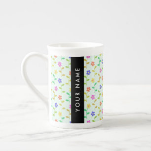 Färgglada blommor, ljusgrön bakgrund, svart benporslin mugg