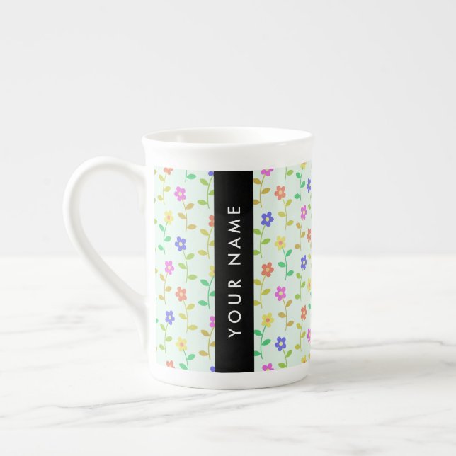 Färgglada blommor, ljusgrön bakgrund, svart benporslin mugg (Vänster)