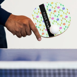 Färgglada blommor, ljusgrön bakgrund, svart pingisracket