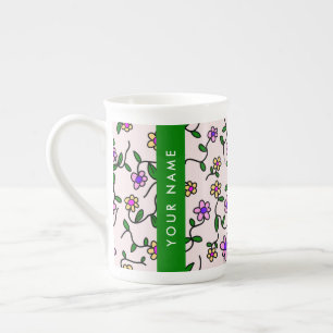 Färgglada blommor, rosa bakgrund, grönt benporslin mugg