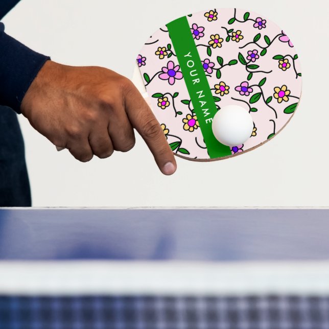 Färgglada blommor, rosa bakgrund, grönt pingisracket (Insitu)