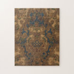 Faux toolat läder-Guld-rullverk Pussel<br><div class="desc">Kantsimulerad verktygskläderdesign ca 1920 har en design av vapenskölden i mitten omgiven av ornate guld-rullning på djup blå och bruna bakgrund.</div>