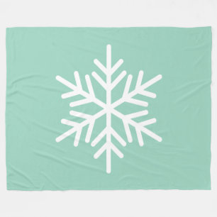 Festiv vit alpin snöflinga på ljus mintgrön teal fleecefilt