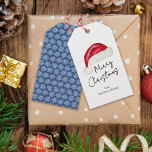 Festive Minimal Santa Hat Cute Whimsical jul Presentetikett<br><div class="desc">Denna minimala märkre med "God jul"-gåva har en hand plockade tomhatt på framsidan och roligten ljusblå poinsettias på en traditionell mörk blått bakgrund på baksidan som tillför en aning nostalgiskt stollig. Originalkonst av Malissa Melrose.</div>