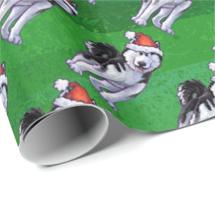 Festlig Husky i den Santa hatten på grönt Presentpapper
