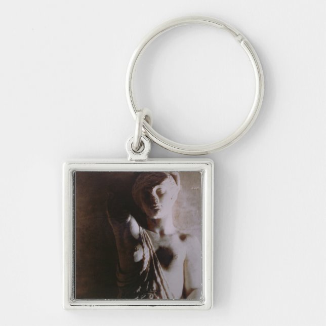 Figur av en amason fyrkantig silverfärgad nyckelring (Framsidan)