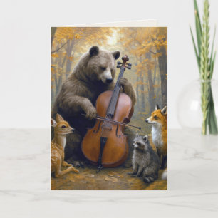 Födelsedagsbjörn spelar cello i höstskog kort
