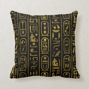 Forntida egyptiska guld-hieroglyfer på svart kudde