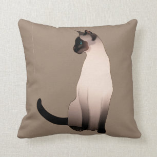 Försegla pekar den Siamese katten på Kudde