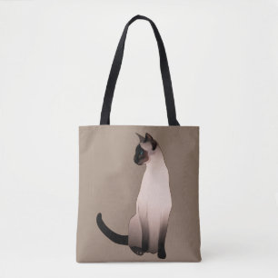 Försegla pekar den Siamese katten på Tygkasse