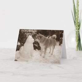 foto av söt akita kyssande snögubbe snö hund helgkort